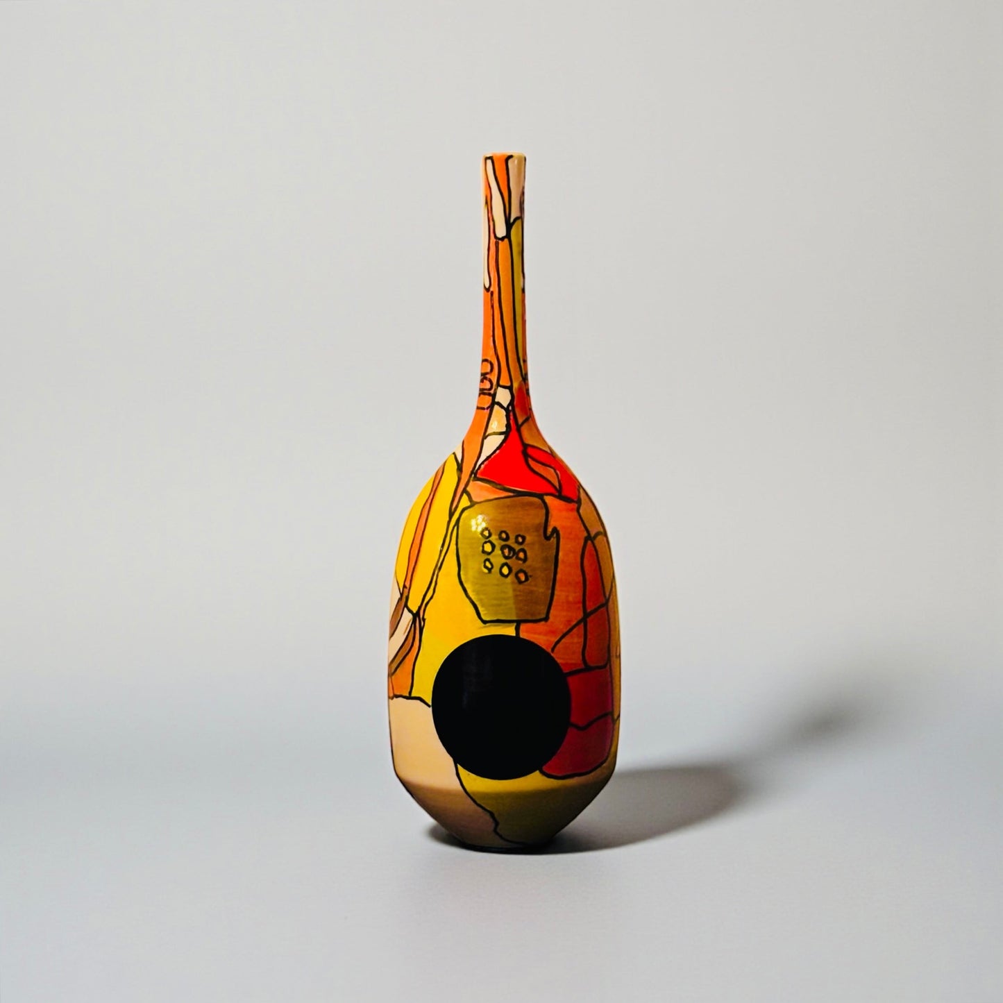 CeramicMeltdown.com Magellanic abstract ceramic vase with red, yellow, and blue cosmic-inspired painted design.