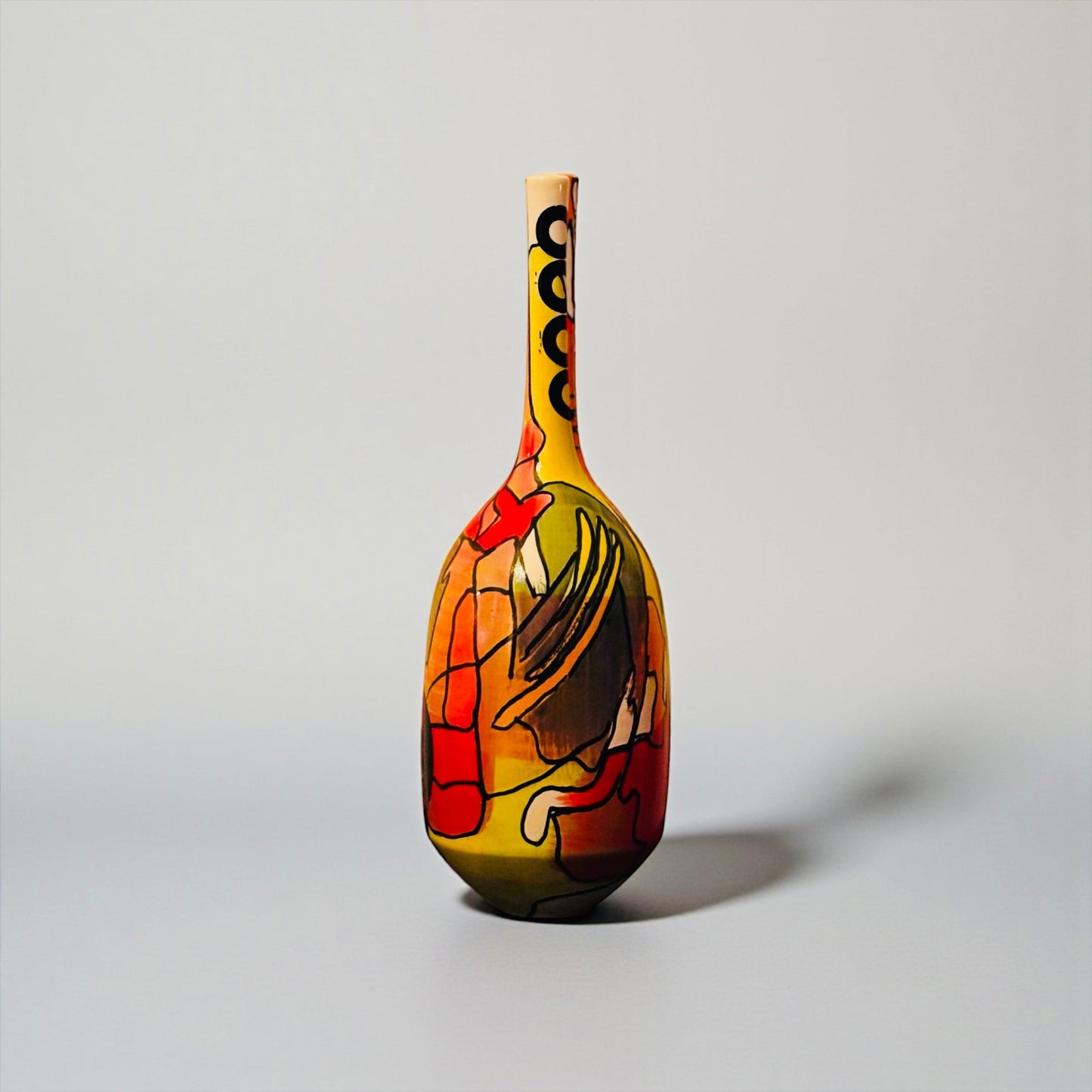 CeramicMeltdown.com Magellanic abstract ceramic vase with red, yellow, and blue cosmic-inspired painted design.