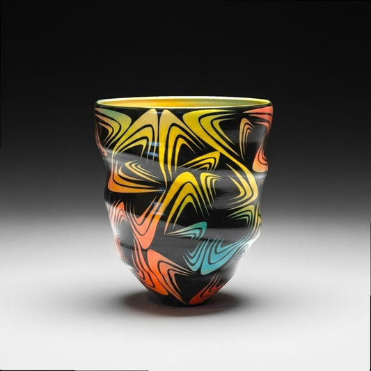 CeramicMeltdown.com black ceramic vase with a vibrant, swirling wave pattern in yellow, orange, and blue.
