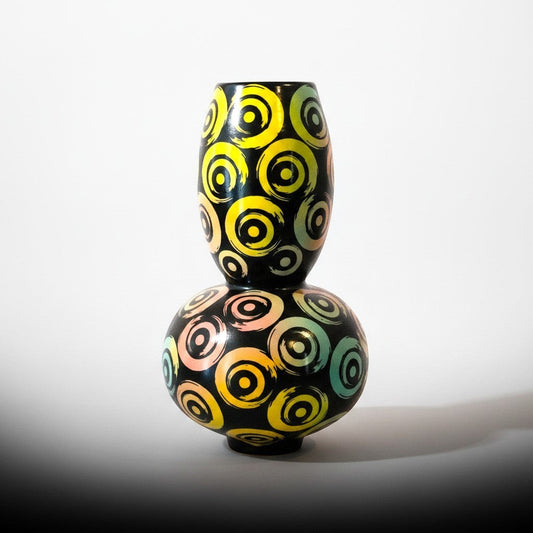 CeramicMeltdown.com Swirl Bubble Ceramic Vessel, black with colorful concentric circle pattern in yellow, pink, and teal.