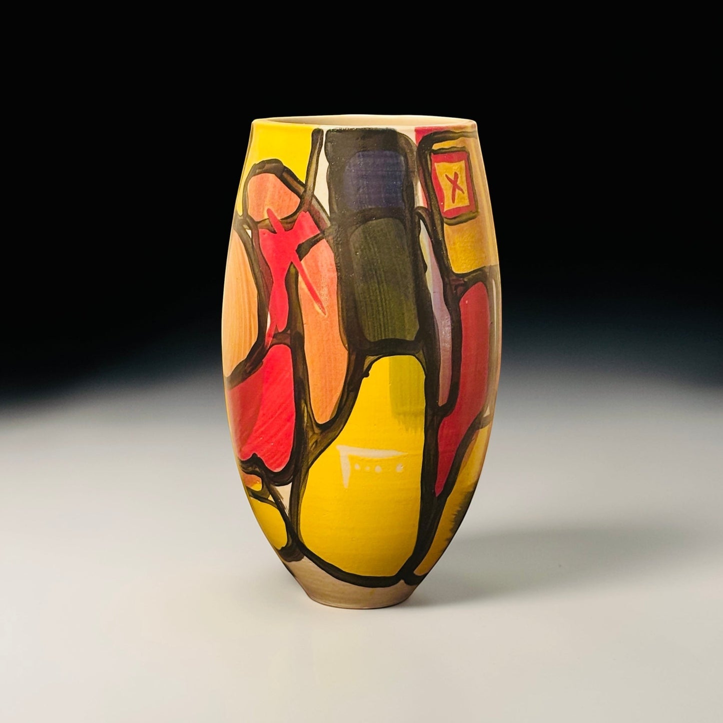 CeramicMeltdown.com Fjord vase with abstract yellow, red, and black geometric pattern. Tall, oval shape.