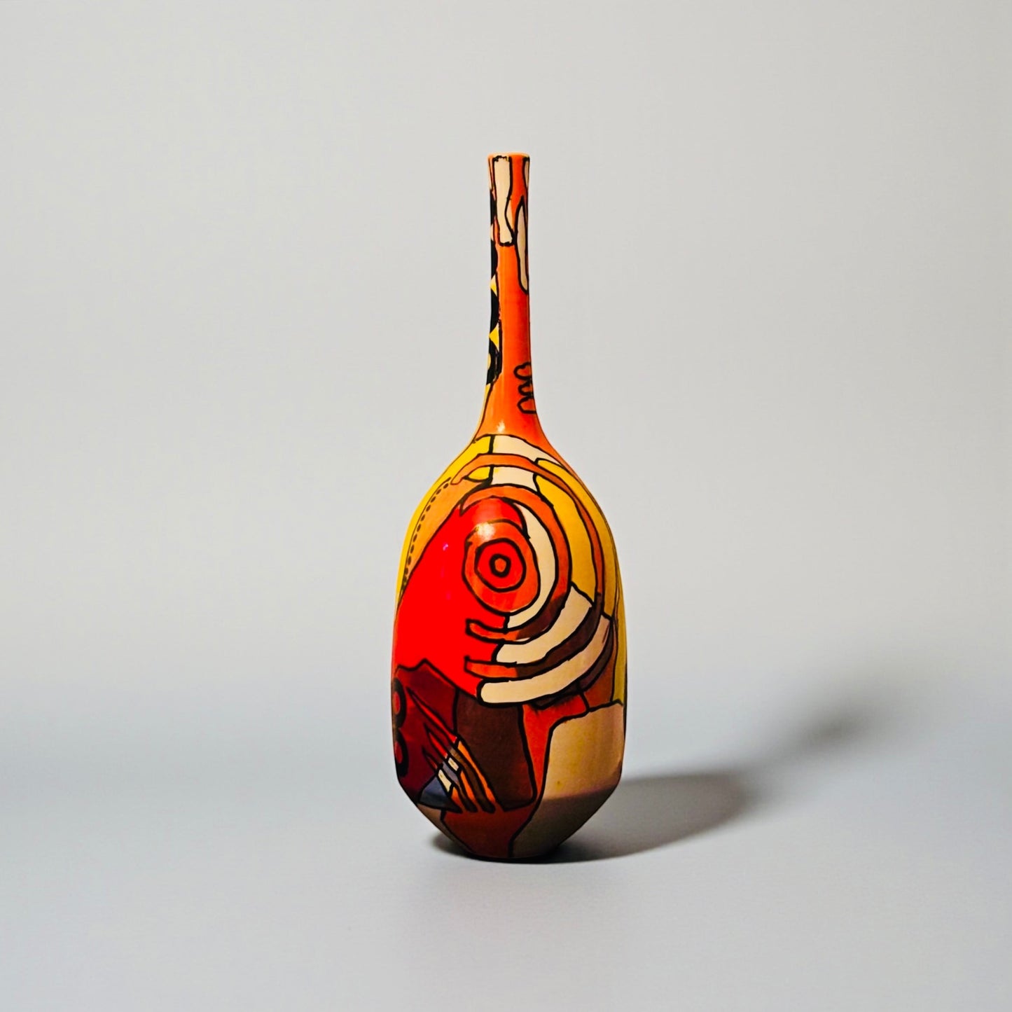 CeramicMeltdown.com Magellanic abstract ceramic vase with red, yellow, and blue cosmic-inspired painted design.