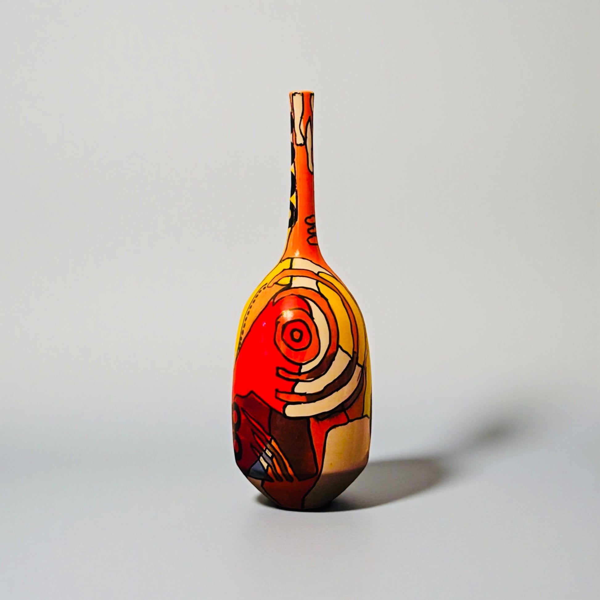 CeramicMeltdown.com Magellanic abstract ceramic vase with red, yellow, and blue cosmic-inspired painted design.