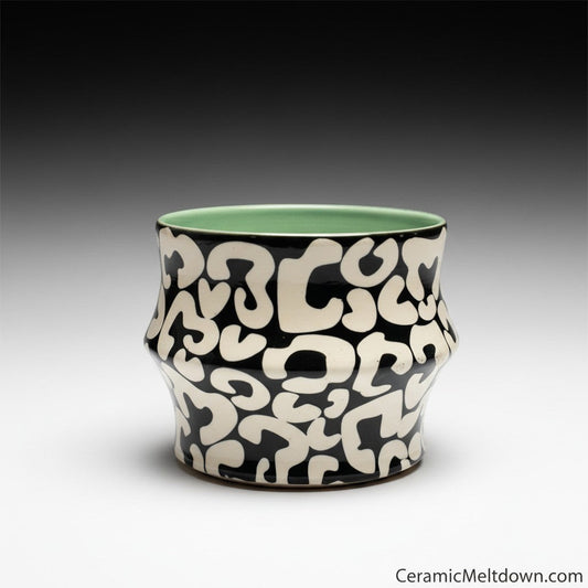 CeramicMeltdown.com abstract black and white coffee cup with mint green interior. Unique alien hieroglyph pattern.