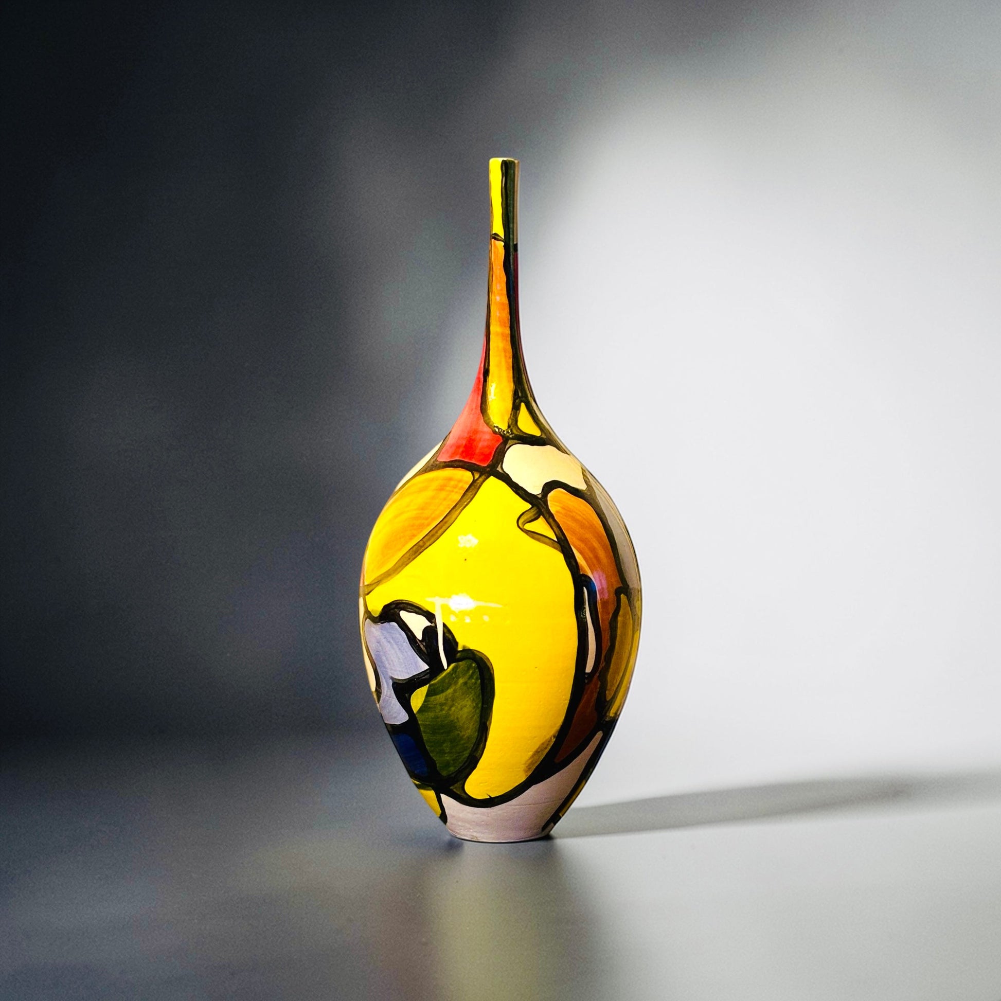 CeramicMeltdown.com Archipelago vase with glossy glaze in yellow, red, paprika, saffron, and emerald abstract design. White ceramic stoneware.