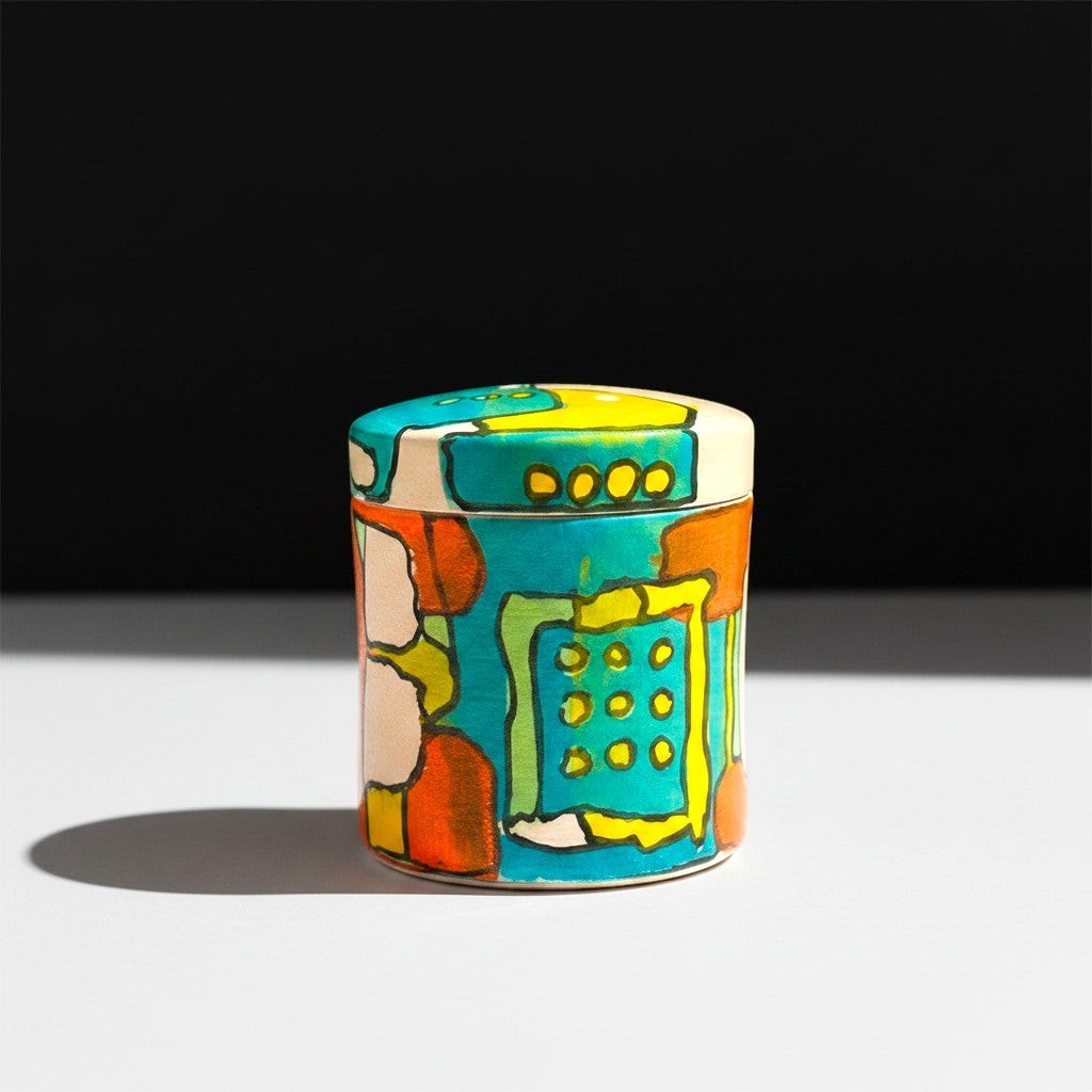 CeramicMeltdown.com hand-painted lidded jar with abstract colorful design in blue, yellow, orange, and green.