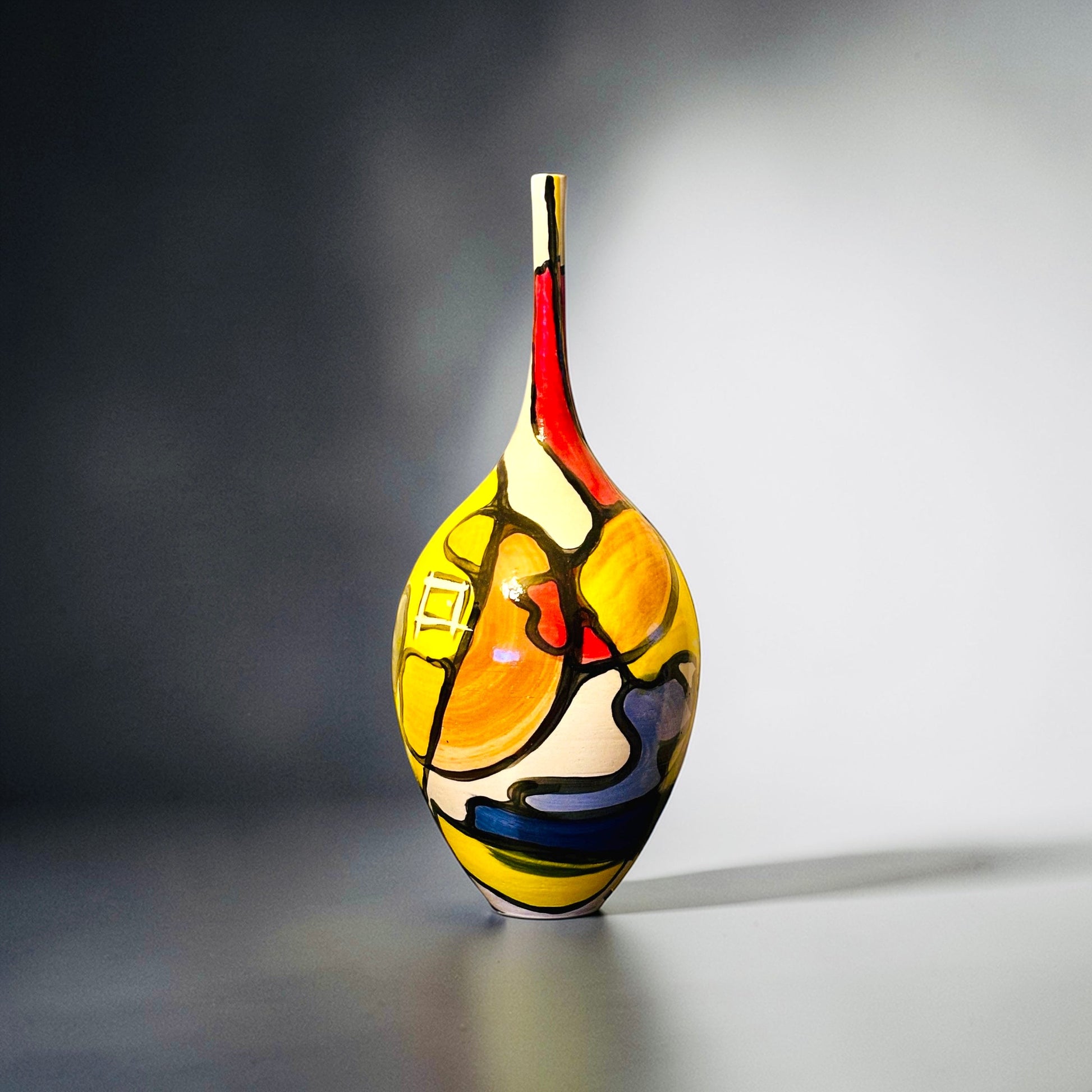 CeramicMeltdown.com Archipelago vase, white stoneware with glossy glaze, hand-painted abstract design in yellow, red, blue, and paprika.