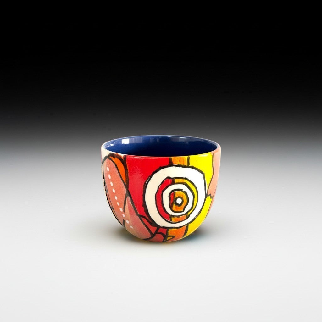 CeramicMeltdown.com wine cup with abstract floral design in red, yellow, and pink, and a blue interior.