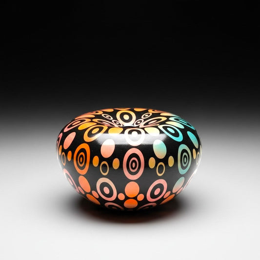 CeramicMeltdown.com black ceramic bowl with an oval pattern in rainbow gradient colours.