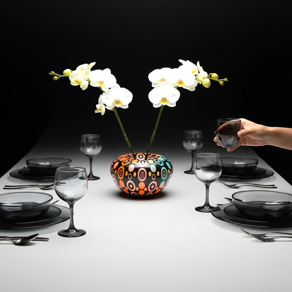 CeramicMeltdown.com Oval Pattern vase with white orchids, set on a table with dark grey dinnerware.
