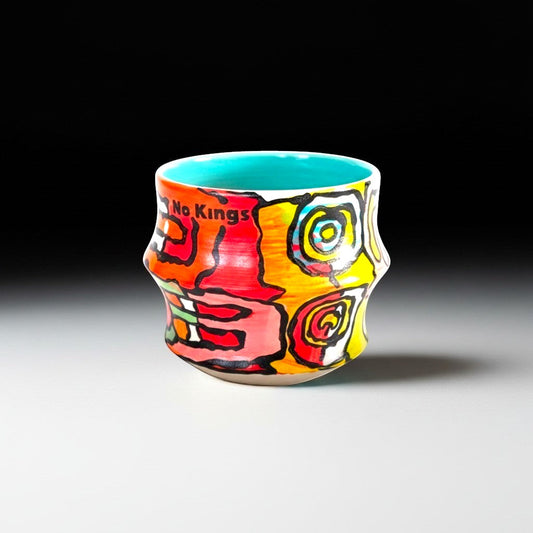 CeramicMeltdown.com Freedom Cup with a vibrant, abstract design in red, pink, yellow, and blue. Features the text "No Kings" in black.
