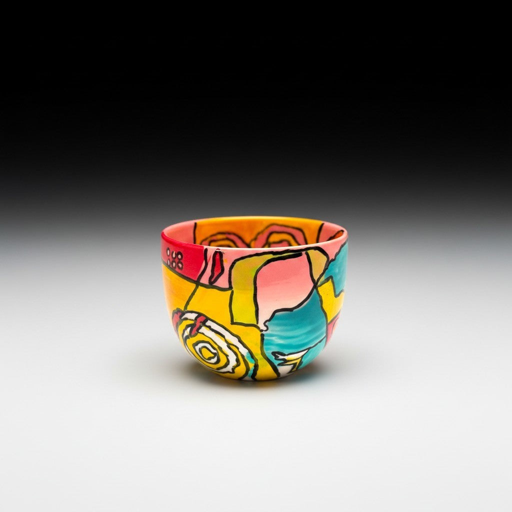 CeramicMeltdown.com abstract art wine cup with yellow, pink, red, and blue swirls and shapes.