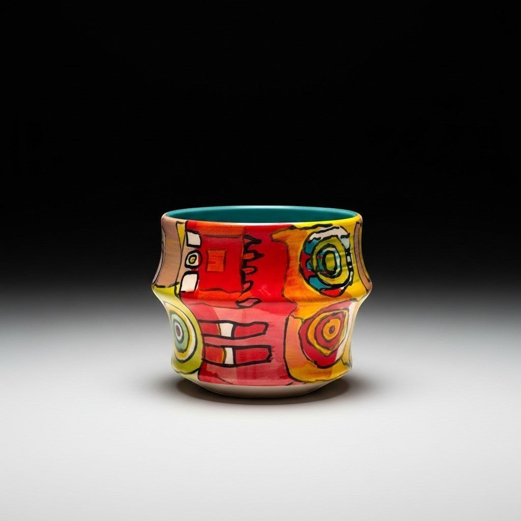 CeramicMeltdown.com Freedom Cup, a vibrant ceramic mug with abstract colorful patterns in red, yellow, and blue, featuring a teal interior.