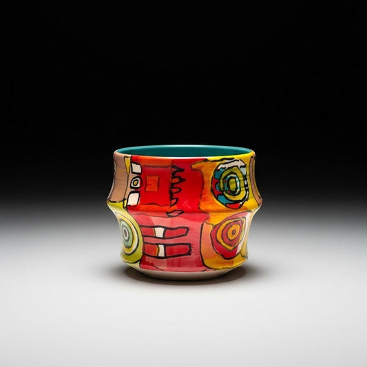 CeramicMeltdown.com Freedom Cup, a vibrant ceramic mug with abstract colorful patterns in red, yellow, and blue, featuring a teal interior.