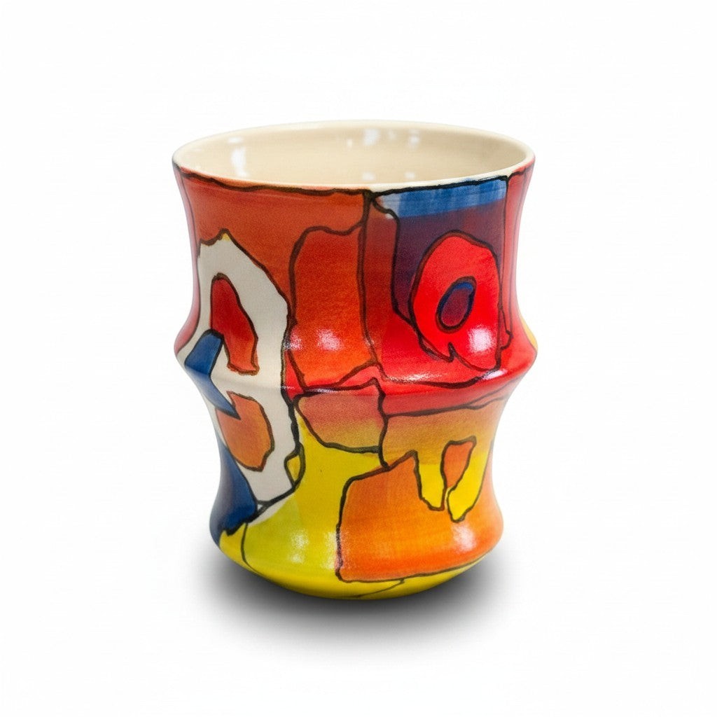 CeramicMeltdown.com hand-painted ceramic tumbler with abstract colourful design in red, orange, yellow, blue and white.