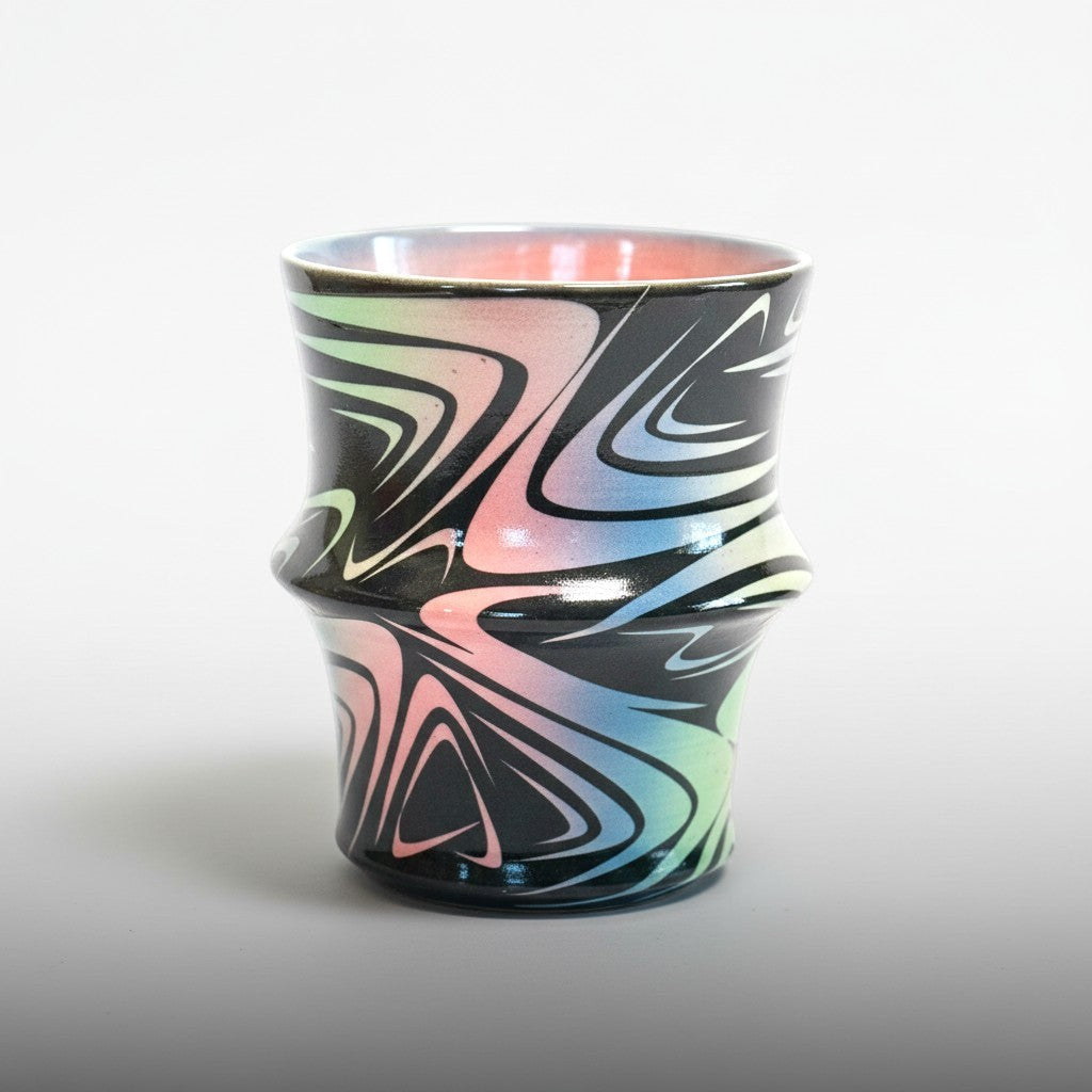 CeramicMeltdown.com Abstract Swirl Tumbler with black base and colorful pink, green, blue swirls. Indented shape for grip.