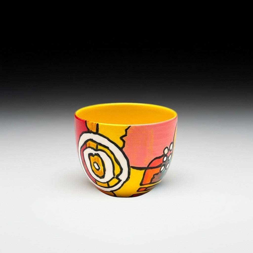 CeramicMeltdown.com wine cup with abstract yellow, pink, and orange design. Features a bright yellow interior.