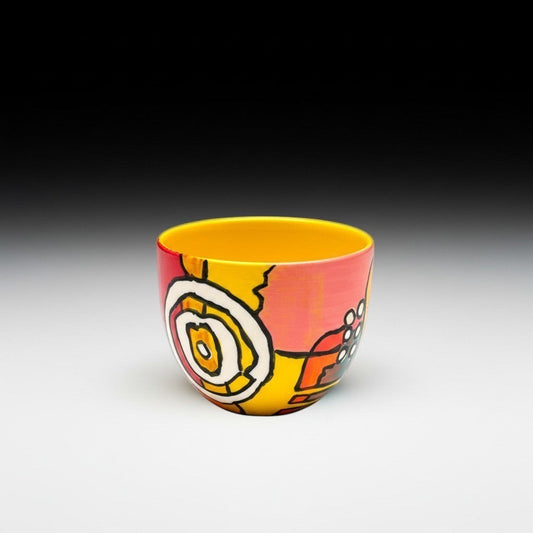 CeramicMeltdown.com wine cup with abstract yellow, pink, and orange design. Features a bright yellow interior.