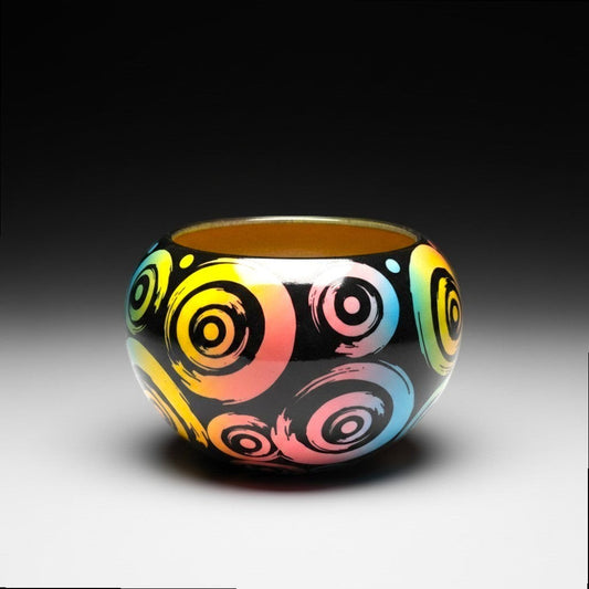 CeramicMeltdown.com black ceramic bowl with colourful rainbow swirl pattern and yellow interior.