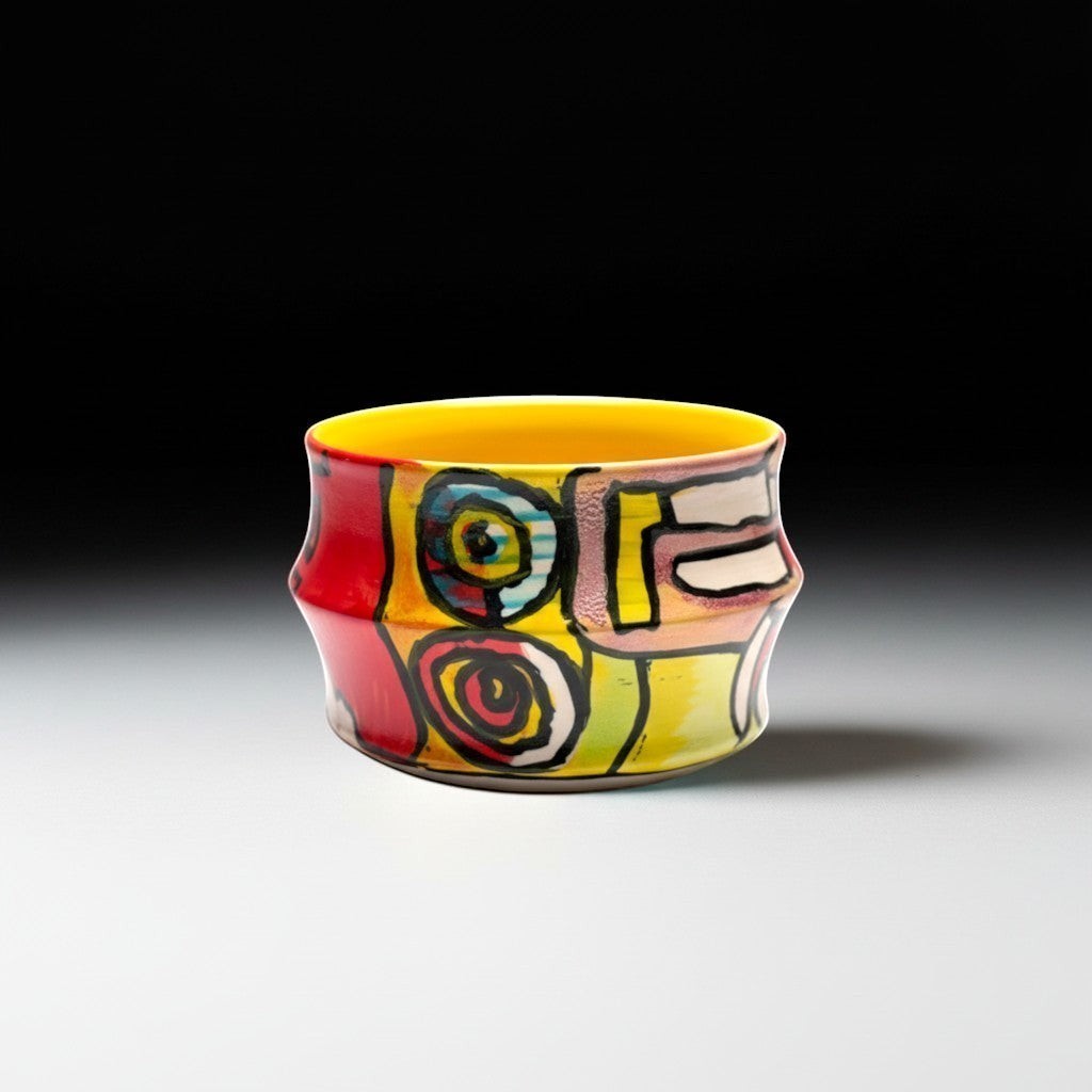 CeramicMeltdown.com Freedom Cup, a vibrant, hand-painted ceramic mug with a yellow interior and abstract colorful designs.