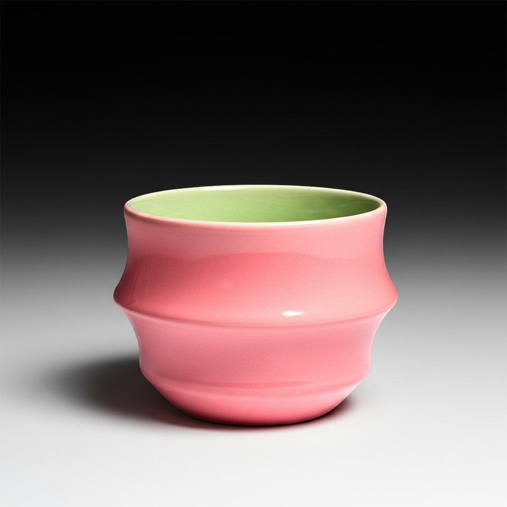 CeramicMeltdown.com coral pink cocktail cup with a light green interior and a ribbed design.